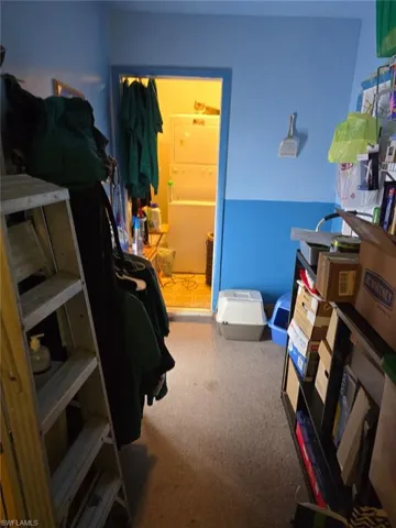 Carpeted bedroom featuring washer / clothes dryer
