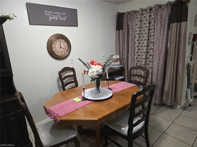 Dining area featuring light tile patterned floors