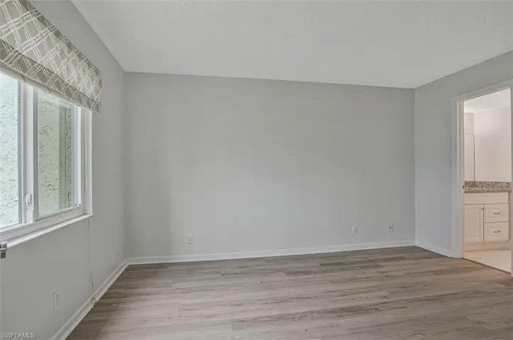 PRIMARY BEDROOM WITH LVP FLOORING