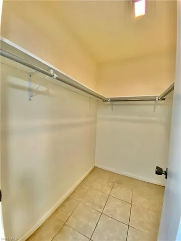 Walk in closet featuring light tile patterned floors