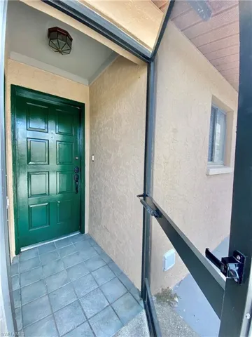 Property entrance featuring stucco siding
