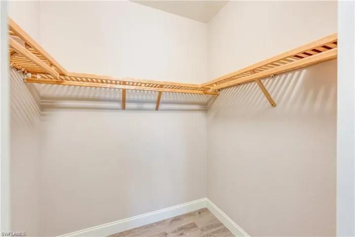 Spacious closet with light wood finished floors