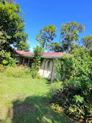 View of side of property with a lawn