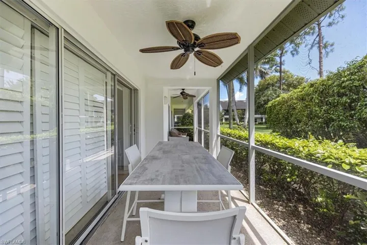 Sunroom with ceiling fan and outdoor dining space