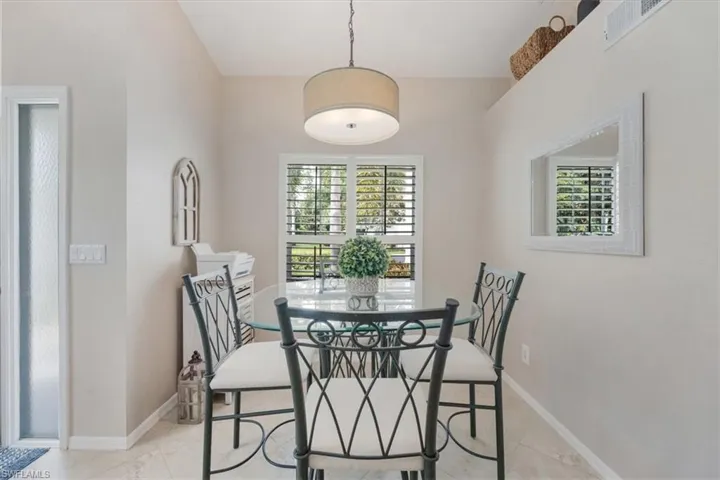 Dining area with healthy amount of natural light and light tile patterned flooring