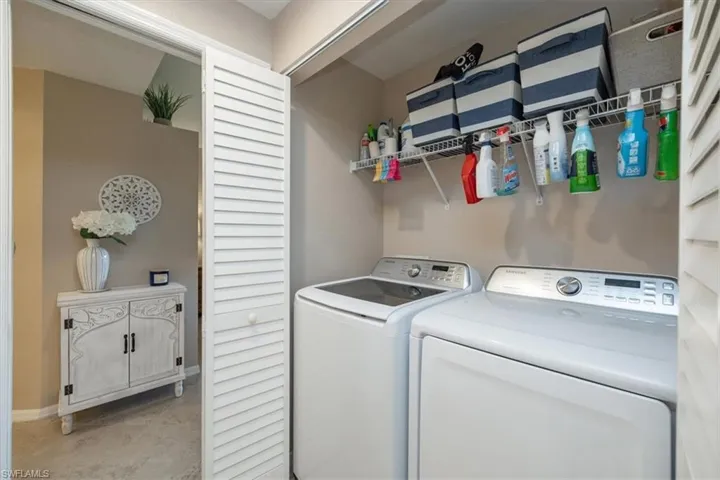 Laundry room with washing machine and dryer and baseboards