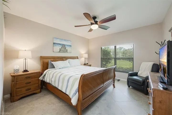 Bedroom featuring light tile patterned flooring and a ceiling fan