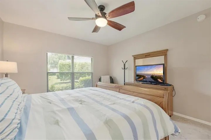 Bedroom with baseboards and a ceiling fan