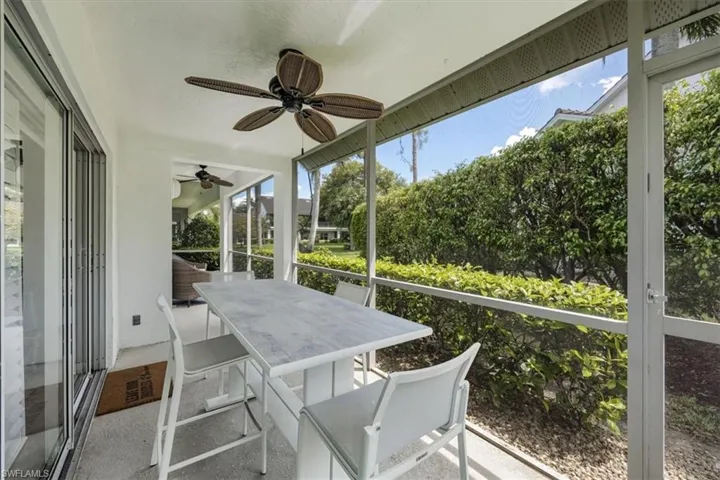 Sunroom with a ceiling fan and outdoor dining space