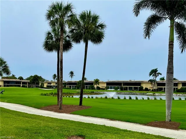 View in the back of the unit towards the golf course and pond with water feature