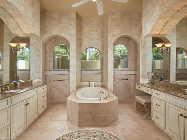 Opulent Master bath with a Roman soaking tub.  And a sizable walk-in shower with its own walled garden.  Dual vanities also with beautiful neutral granite tops