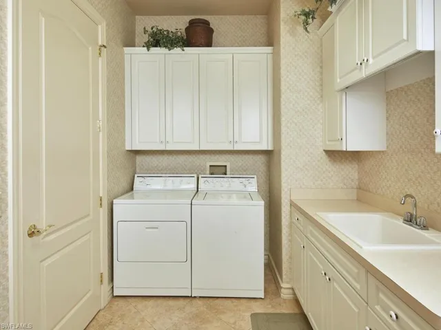 Laundry room with lots of cabinet storage, large closet and second refrigerator