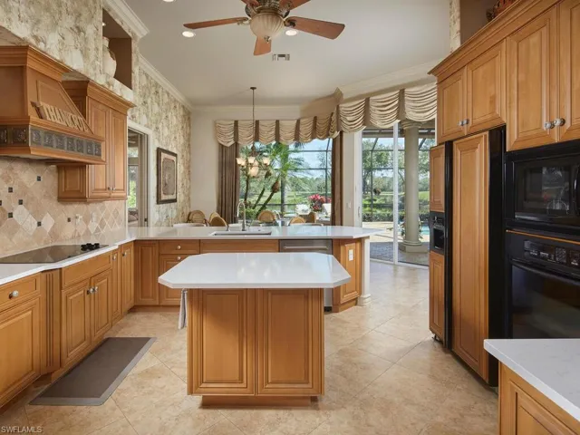 Lots of solid wood custom cabinetry in addition to an island and 'cabinet faced' refrigerator.  Superb view looking toward the breakfast nook