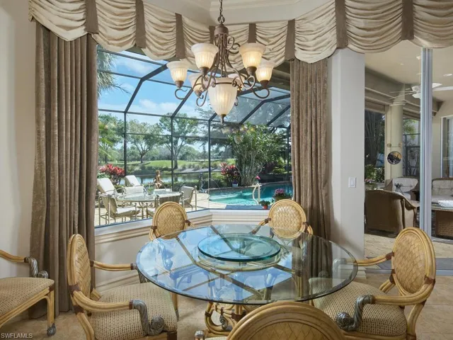 Breakfast nook enjoys a beautiful view of the lanai, lake, preserve and distant golf