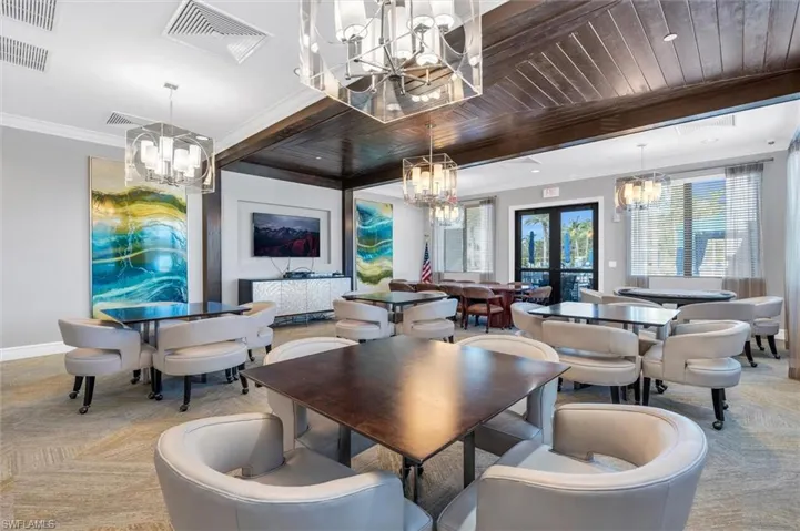 Dining area featuring wood ceiling, french doors, and crown molding