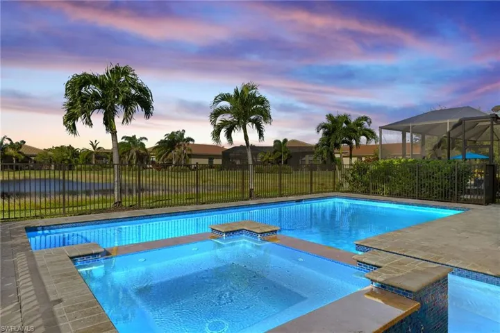 Entertainers' Delight! Sunset Views, Custom Pool / Spa, Mood lighting, Fireplace feature, Mosquito Mist System, Travertine tile, yard with Waterfront view.