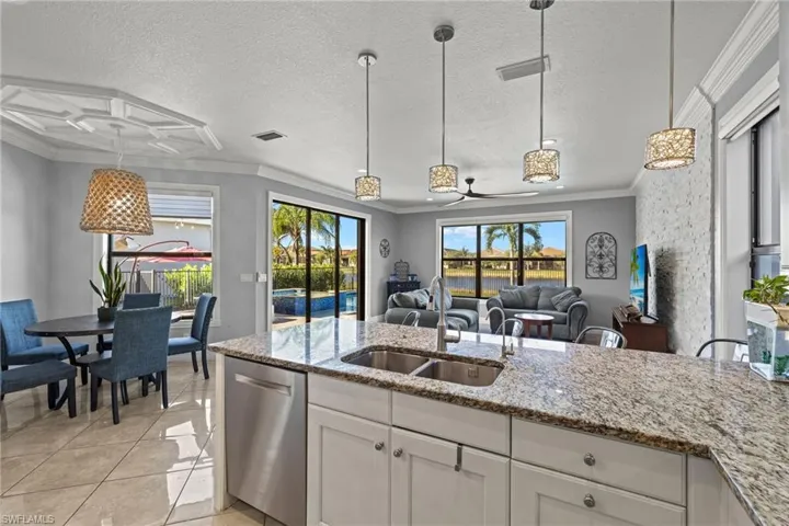 Kitchen featuring white cabinetry, ceiling fan, dishwasher, and sink