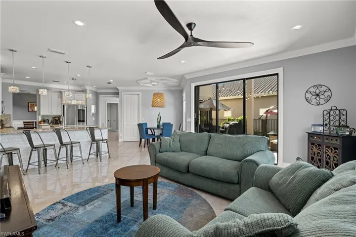 Huge Great room with tons of light and upgrades , ceiling fan and ornamental molding