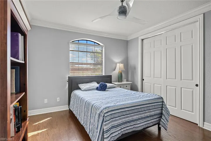 Bedroom  #6 featuring Jack N Jill Bathroom, ceiling fan, a closet, dark hardwood / wood-style flooring, and ornamental molding