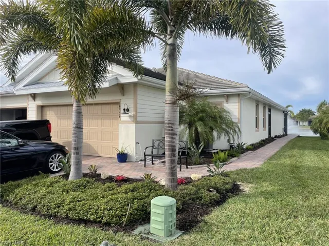 View of property exterior featuring a yard and a garage