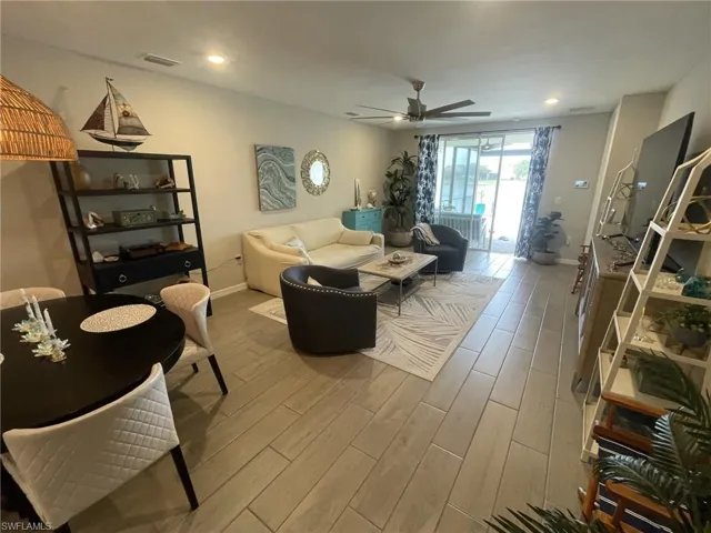 Living room with hardwood / wood-style floors and ceiling fan