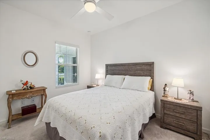 Carpeted bedroom with ceiling fan