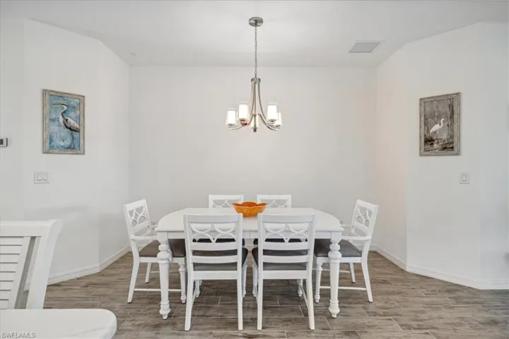 Dining space featuring wood-type flooring and a chandelier