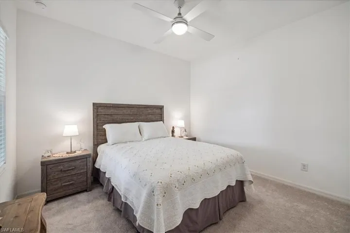 Bedroom featuring light carpet and ceiling fan