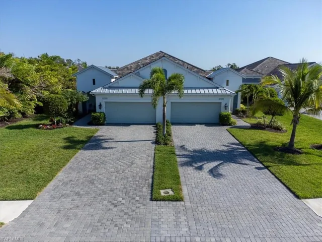View of front of house with a garage and a front yard