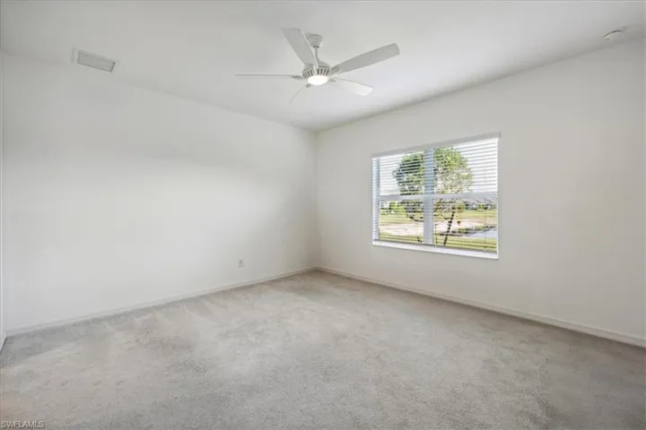 Empty room with carpet and ceiling fan