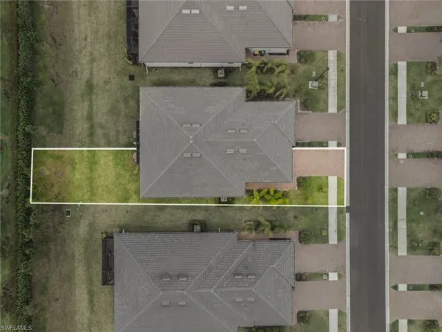 Aerial view of property and surrounding area featuring property parcel outlined