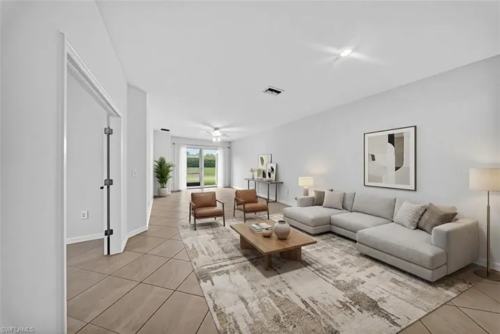 Living room featuring light tile patterned floors and a ceiling fan