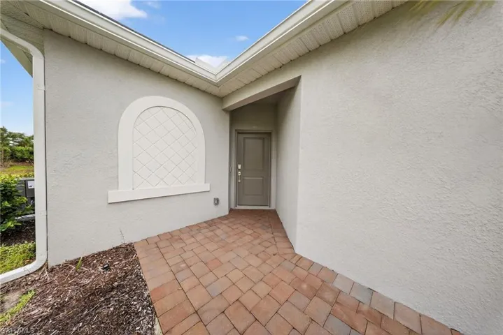 Doorway to property with stucco siding