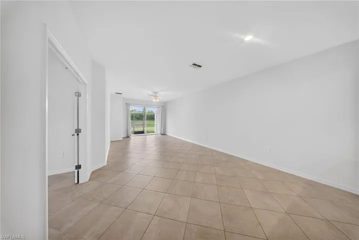 Spare room with ceiling fan and light tile patterned flooring