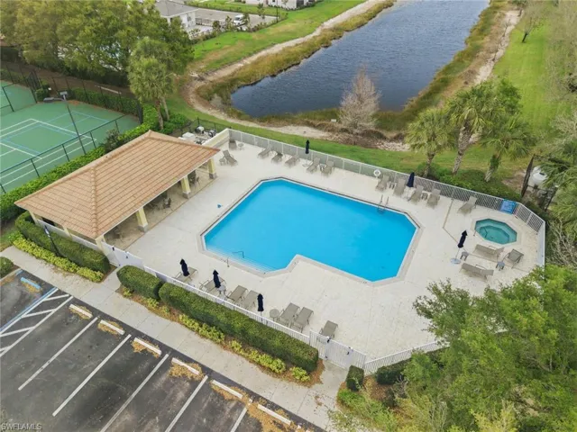Community pool with a patio, a water view, and a community hot tub