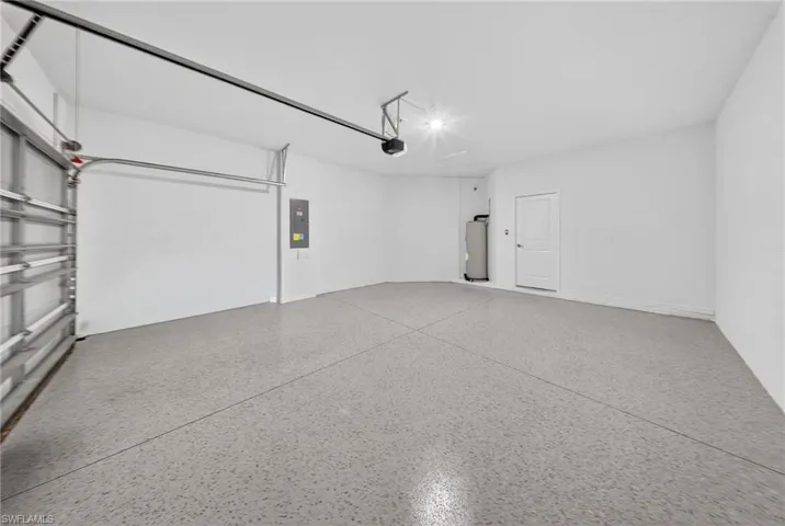 Garage with water heater and electric panel