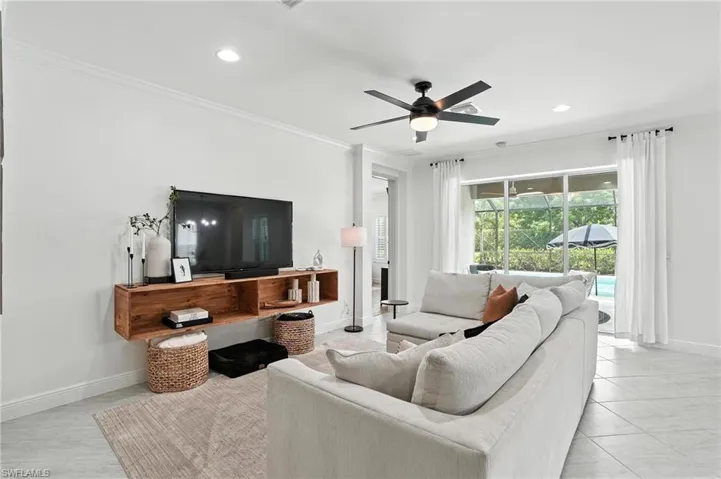 Living room featuring crown molding, a ceiling fan, and recessed lighting
