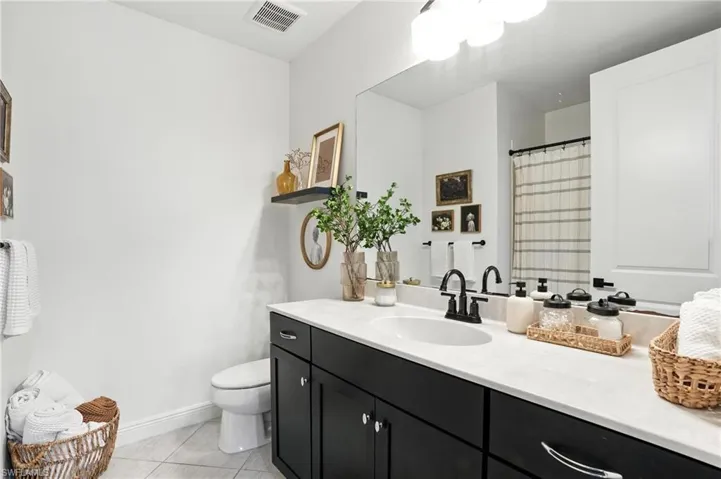 Bathroom featuring vanity and tile patterned floors