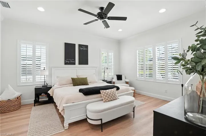 Bedroom featuring crown molding, light wood finished floors, recessed lighting, and a ceiling fan