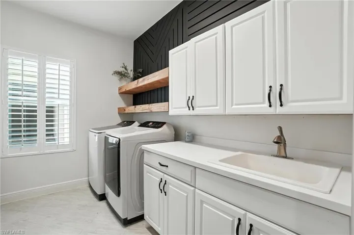Laundry room with cabinet space and washing machine and clothes dryer