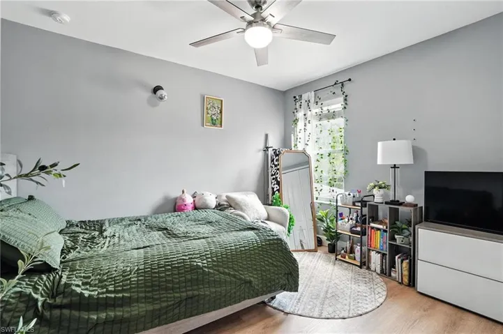 Bedroom with wood finished floors and a ceiling fan