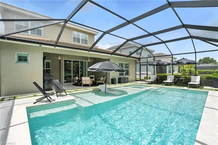 Swimming pool featuring a patio area, a ceiling fan, and screen enclosure