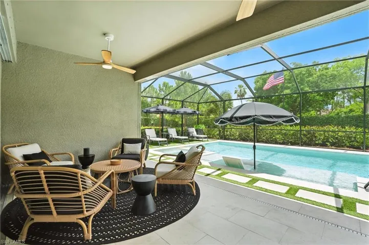 View of patio featuring an outdoor pool, a ceiling fan, and screen enclosure