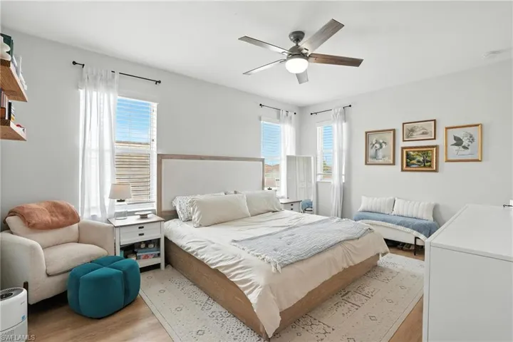 Bedroom with light wood finished floors and ceiling fan