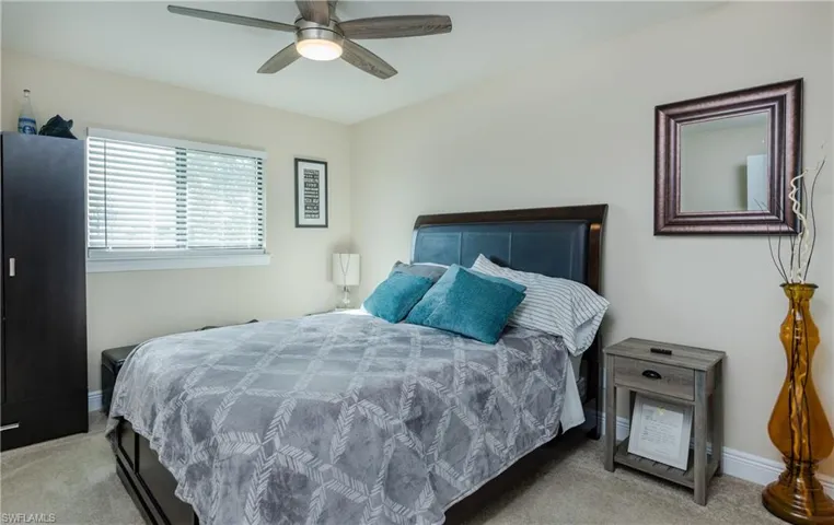 Bedroom featuring light colored carpet and ceiling fan