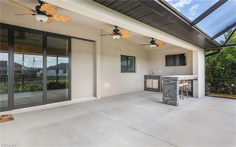 View of patio / terrace with an outdoor bar and a lanai