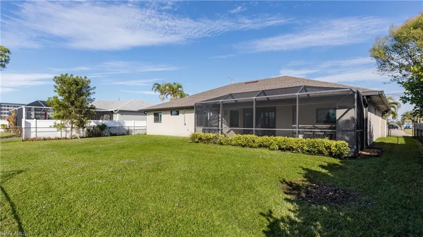 Rear view of house with mature landscaping