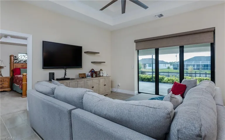 Living room with double tray, ceiling fan, crown molding and remote control slider shade