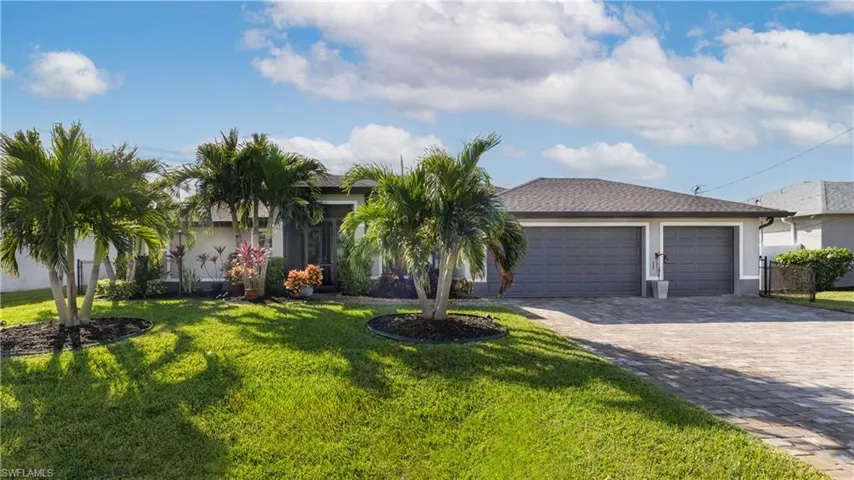 Street view featuring a front yard and a 3-car garage