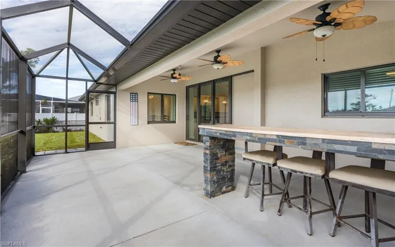 Screened lanai with custom built bar offering views of the canal